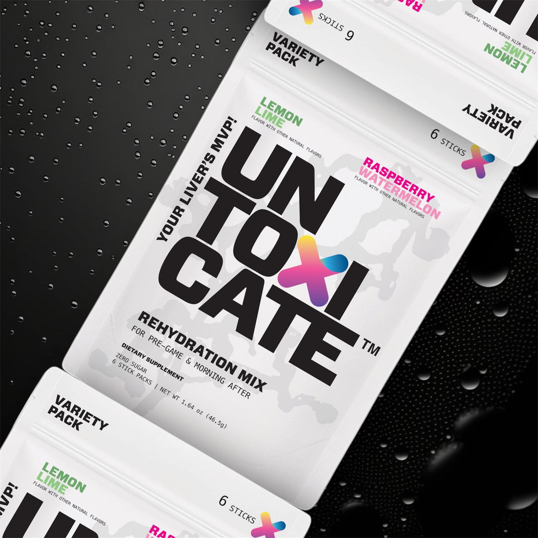 Untoxicate rehydration mix packets on a black textured background