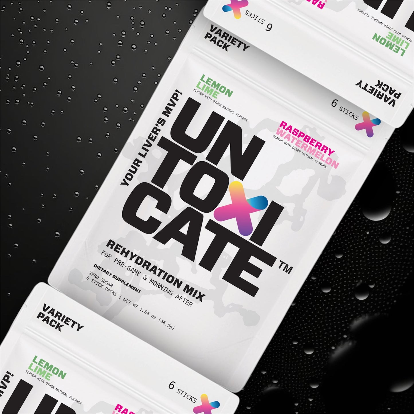 Untoxicate rehydration mix packets on a black textured background